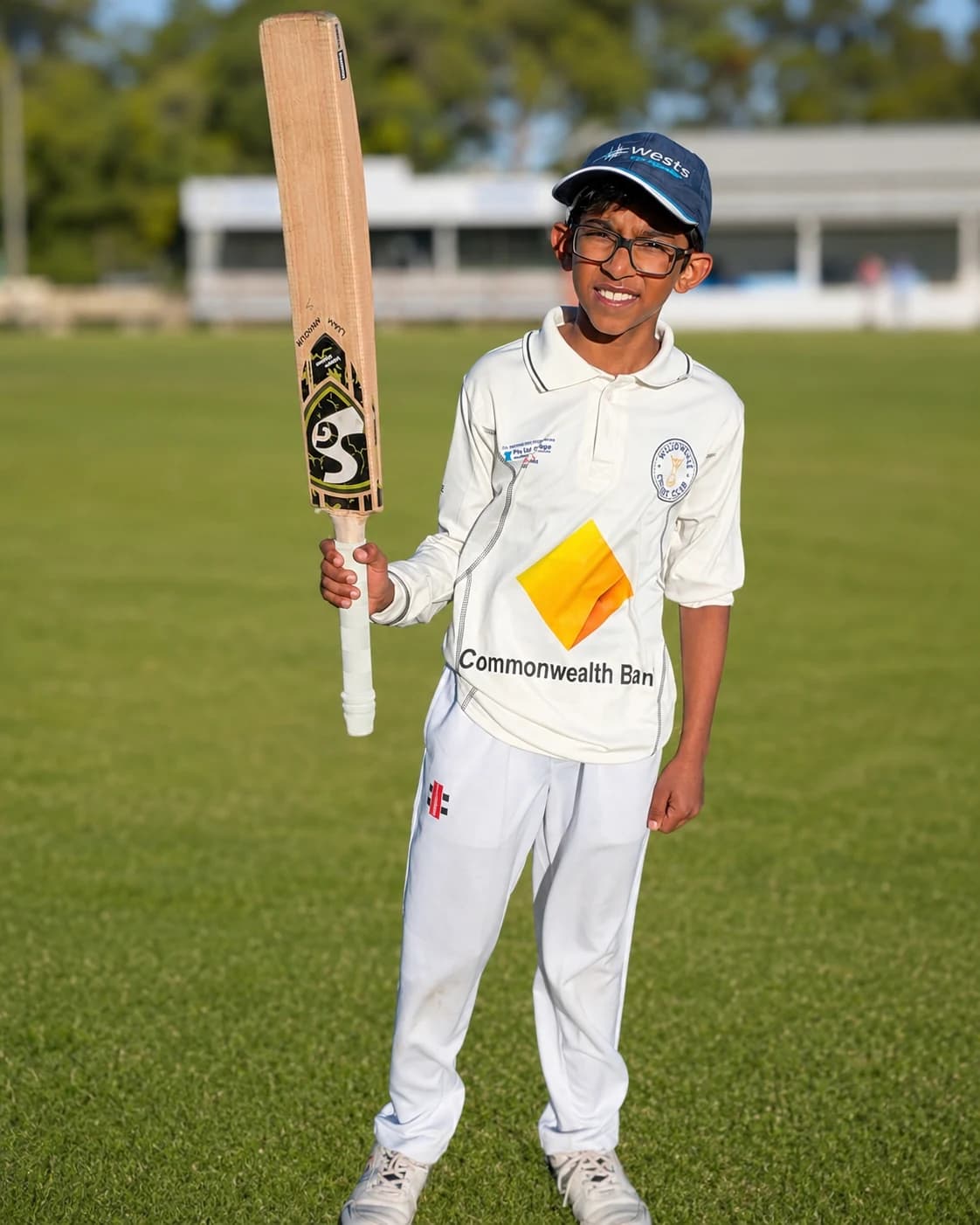 Willowdale junior player holding a cricket bat